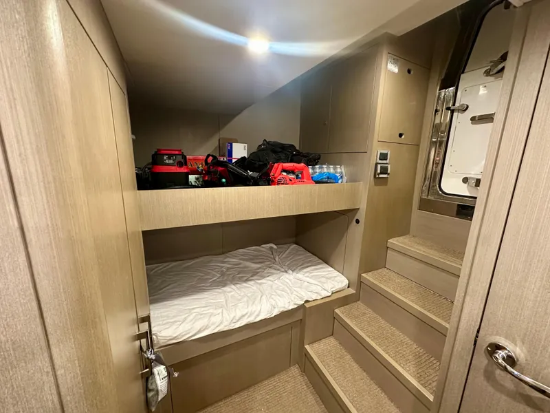 Slide: The Image of 2024 Sirena 68 yacht interior cabin with bunk bed and storage. - 48