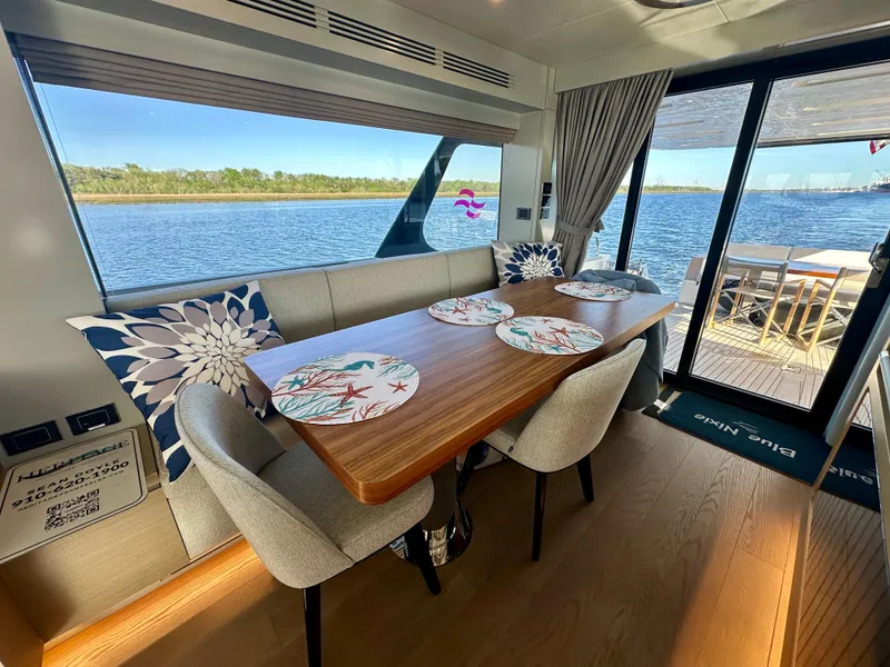 Slide: The Image of Luxurious interior of 2024 Sirena 68 yacht with elegant dining area and scenic water view. - 7