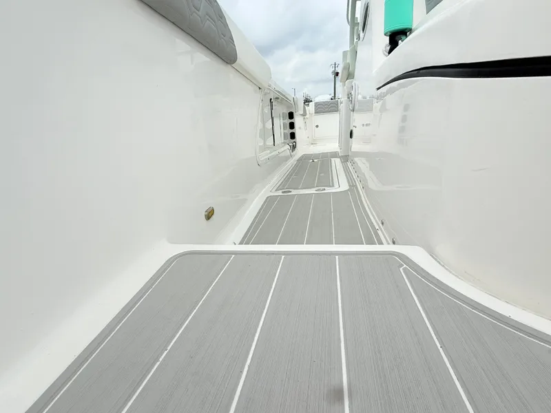 Slide: The Image of 2022 Twin Vee 280 GFX CC boat deck with sleek, modern design and gray flooring. - 16