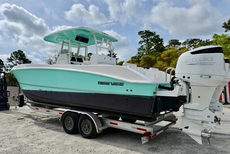 Slide: The Image of 2022 Twin Vee 280 GFX CC boat on trailer with Suzuki outboard engines. - 23
