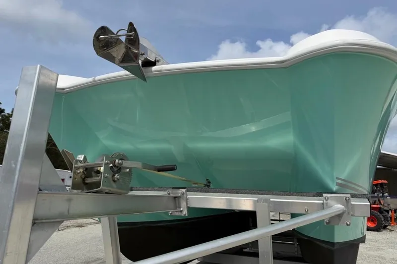 Slide: The Image of 2022 Twin Vee 280 GFX CC boat on trailer, turquoise hull, stainless steel anchor. - 26