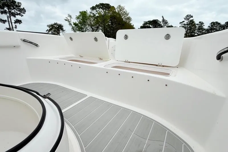 Slide: The Image of 2022 Twin Vee 280 GFX CC boat interior with open storage compartments and sleek design. - 28
