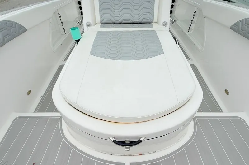 Slide: The Image of 2022 Twin Vee 280 GFX CC boat interior with cushioned seating and cup holder. - 29