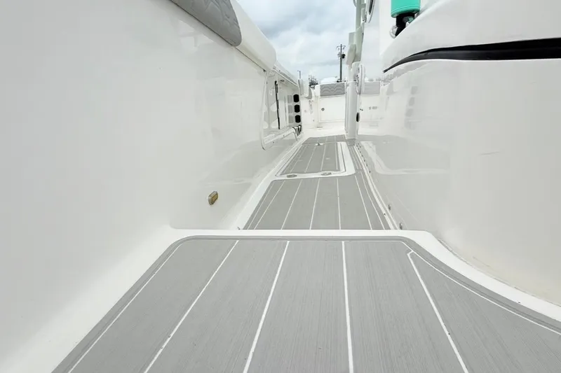 Slide: The Image of 2022 Twin Vee 280 GFX CC boat deck with sleek, modern design and gray flooring. - 30