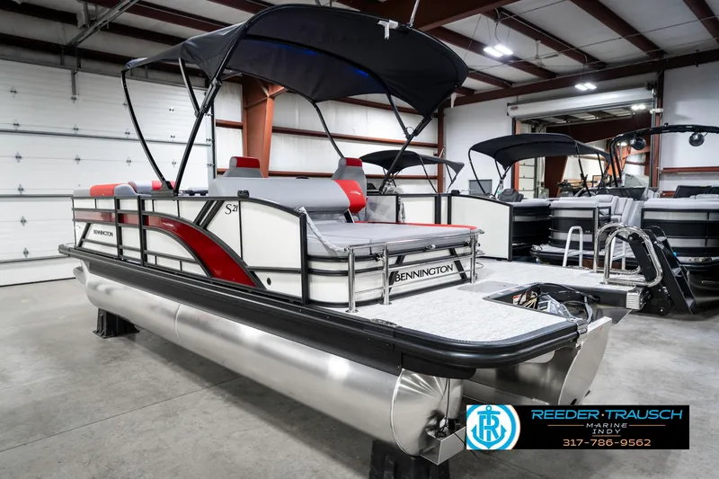Slide: The Image of 2025 Bennington 21 SSB pontoon boat in showroom with canopy and seating. - 10