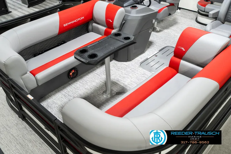Slide: The Image of 2025 Bennington 21 SSB boat interior with red and gray seating, cup holders, and console. - 12