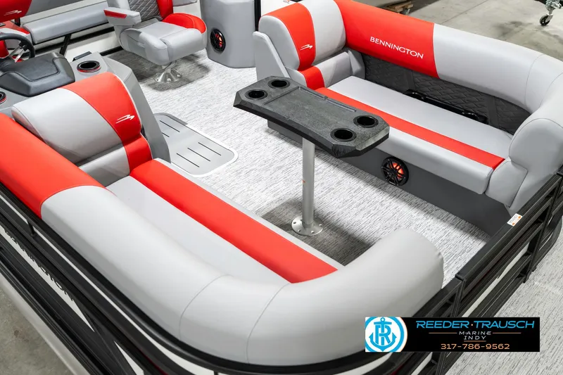 Slide: The Image of 2025 Bennington 21 SSB pontoon boat interior with red and gray seating and table. - 13