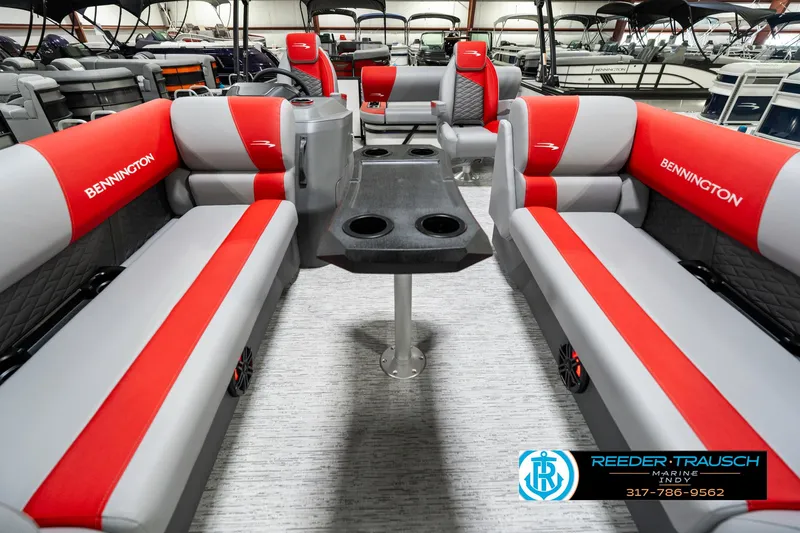 Slide: The Image of 2025 Bennington 21 SSB pontoon boat interior with red and gray seating and table. - 16