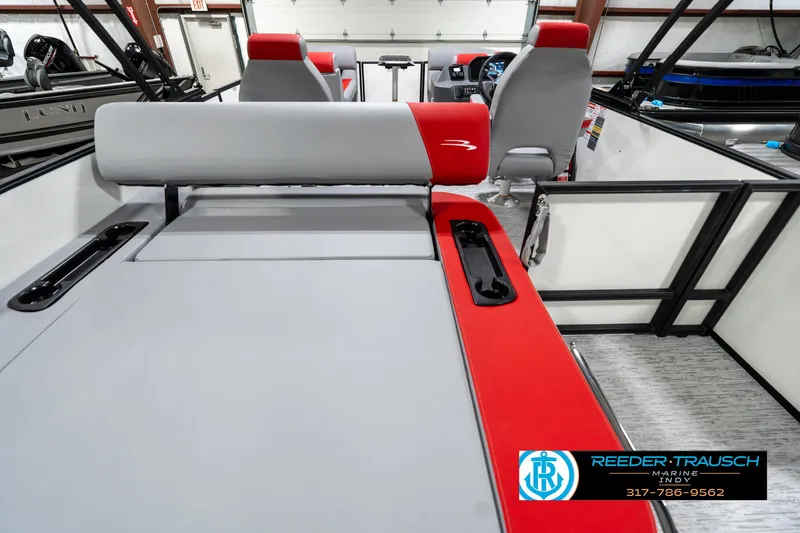 Slide: The Image of 2025 Bennington 21 SSB boat interior with red and gray seating, showcased by Reeder-Trausch Marine. - 19