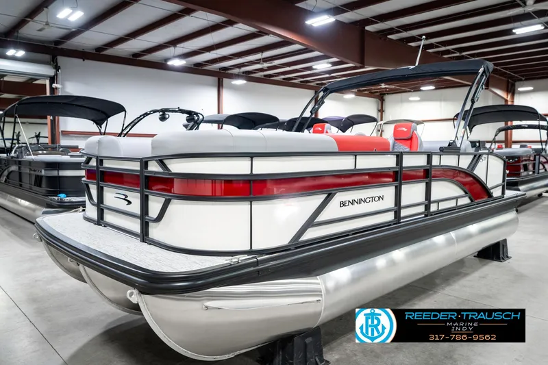 Slide: The Image of 2025 Bennington 21 SSB pontoon boat in showroom, featuring sleek design and modern amenities. - 2