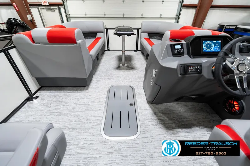 Slide: The Image of 2025 Bennington 21 SSB pontoon boat interior with red and gray seating, modern dashboard. - 20
