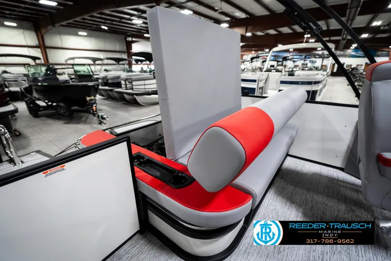 Slide: The Image of 2025 Bennington 21 SSB boat interior with red and gray seating in showroom. - 27