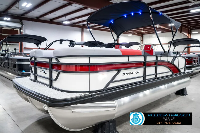 Slide: The Image of 2025 Bennington 21 SSB pontoon boat in showroom, featuring sleek design and modern amenities. - 3