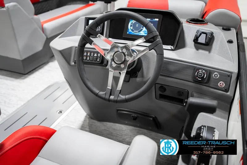 Slide: The Image of 2025 Bennington 21 SSB boat dashboard with steering wheel and control panel. - 32