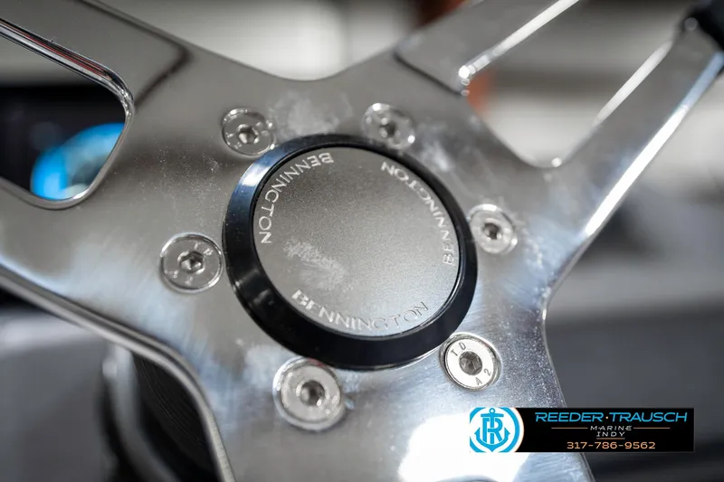 Slide: The Image of Steering wheel of 2025 Bennington 21 SSB boat, featuring sleek metallic design. - 34
