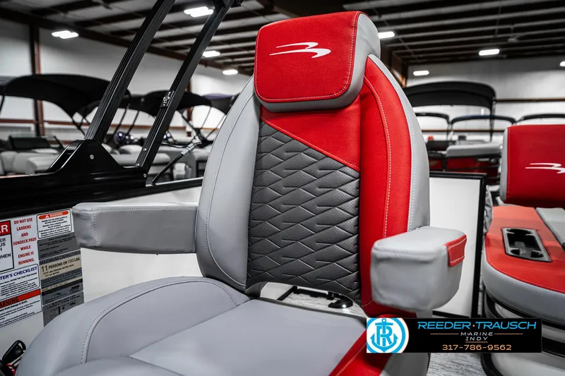 Slide: The Image of 2025 Bennington 21 SSB boat seat with red and gray upholstery in showroom. - 41
