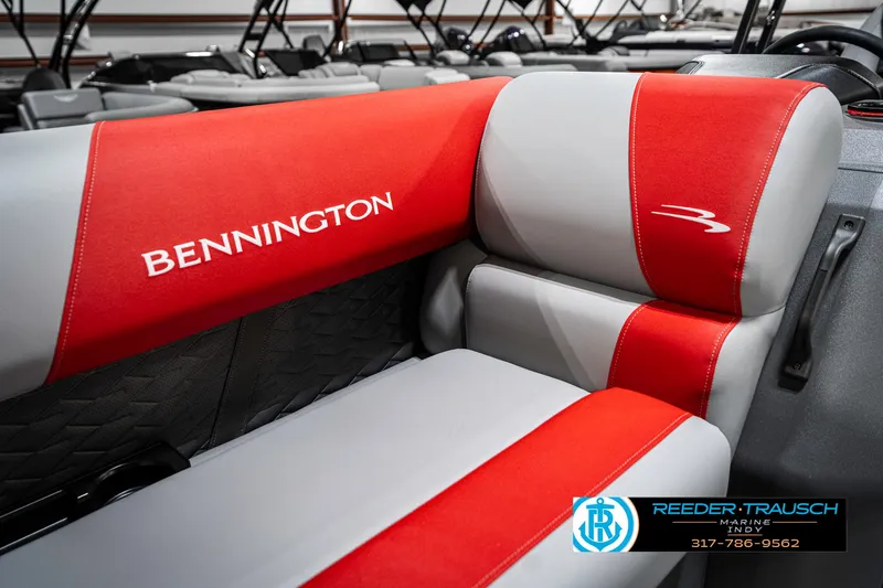Slide: The Image of 2025 Bennington 21 SSB boat interior with red and gray seating, featuring logo details. - 42