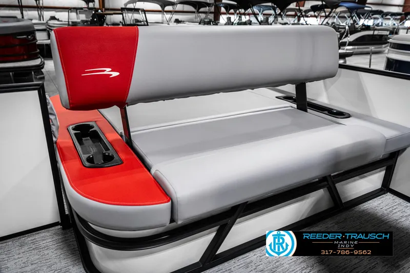 Slide: The Image of 2025 Bennington 21 SSB boat seat with red and gray upholstery, cup holders visible. - 43
