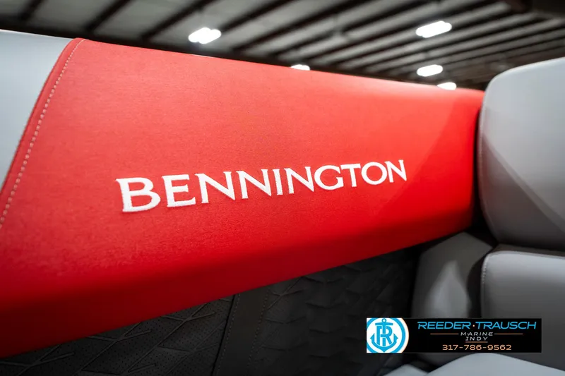 Slide: The Image of 2025 Bennington 21 SSB boat seat with red and gray upholstery in showroom. - 46
