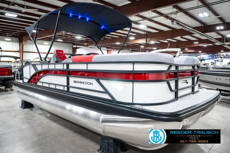 Slide: The Image of 2025 Bennington 21 SSB pontoon boat with canopy in showroom setting. - 6