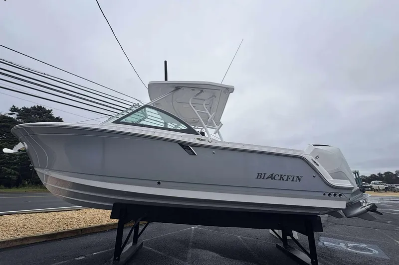 The Image of 2025 Blackfin 252 DC boat displayed outdoors on a stand. - 0