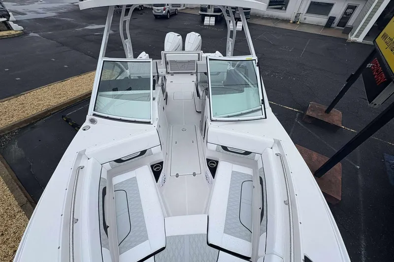 Slide: The Image of 2025 Blackfin 252 DC boat with spacious seating and modern design in a parking lot. - 12