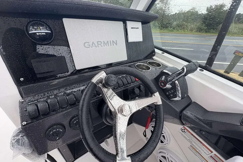 Slide: The Image of 2025 Blackfin 252 DC boat dashboard with Garmin navigation and Mercury controls. - 16