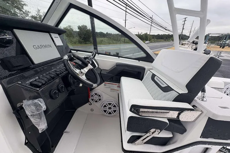 Slide: The Image of 2025 Blackfin 252 DC boat interior with Garmin navigation system and modern seating. - 17