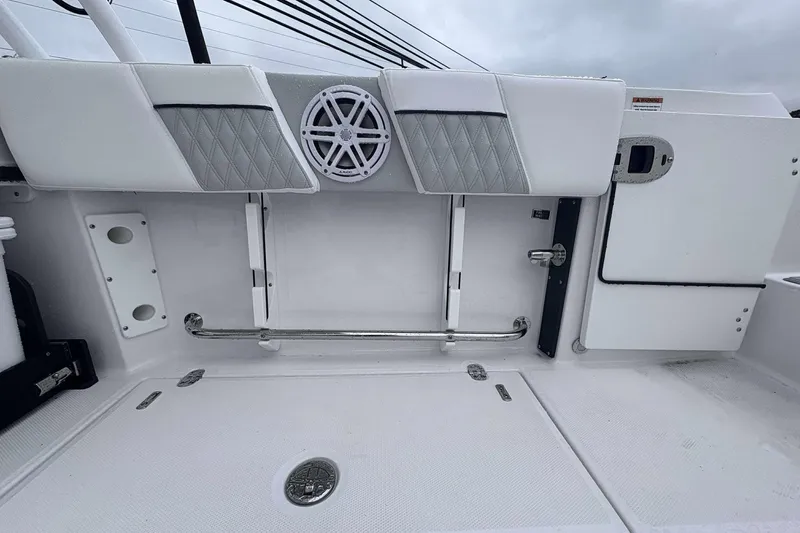 Slide: The Image of 2025 Blackfin 252 DC boat interior with white seating and speaker detail. - 21