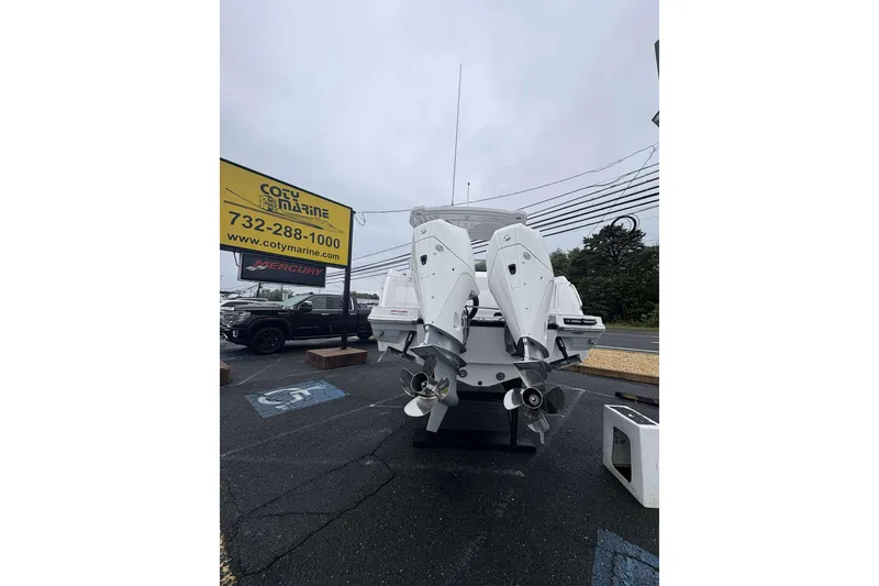 Slide: The Image of 2025 Blackfin 252 DC boat with dual outboard engines at Coty Marine dealership. - 30