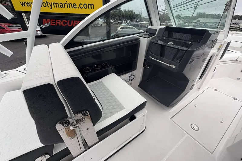 Slide: The Image of 2025 Blackfin 252 DC boat interior with sleek seating and modern dashboard design. - 8