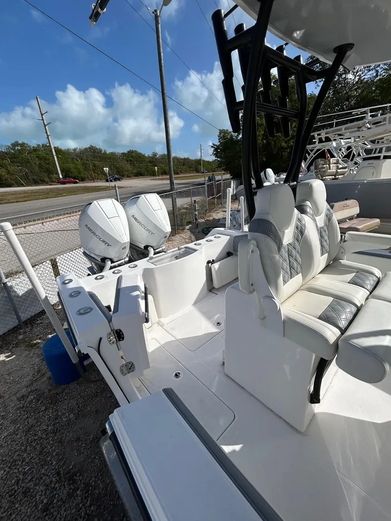 Slide: The Image of 2024 Streamline Ace boat with dual engines and cushioned seating, parked outdoors. - 5