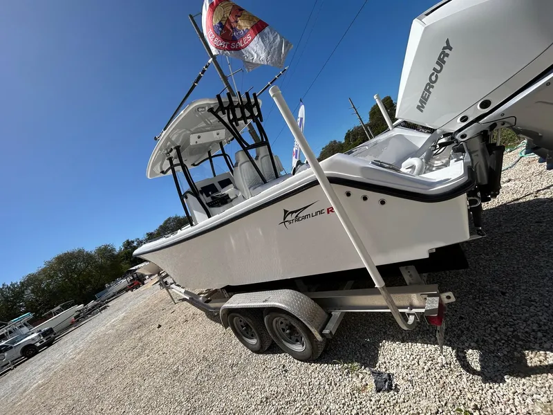Slide: The Image of 2024 Streamline Ace boat on trailer with Mercury engine, displayed outdoors. - 6