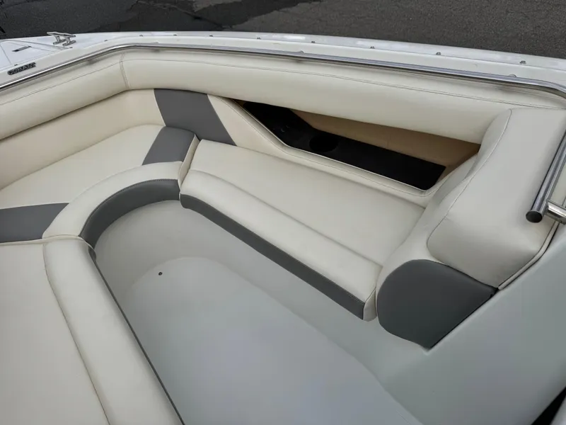 Slide: The Image of Interior seating of a 1994 Cobalt 222 boat, featuring white and gray upholstery. - 11