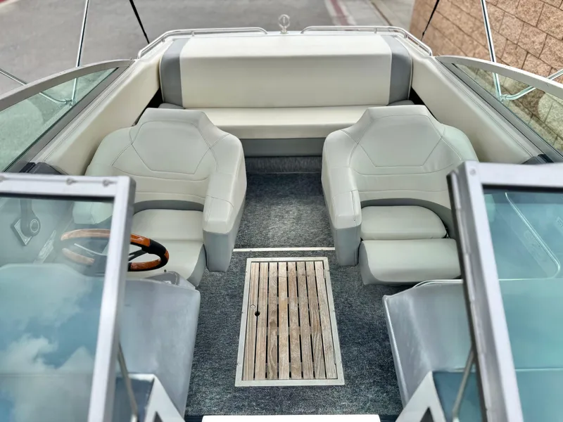 Slide: The Image of Interior of a 1994 Cobalt 222 boat with white seating and wooden accents. - 13