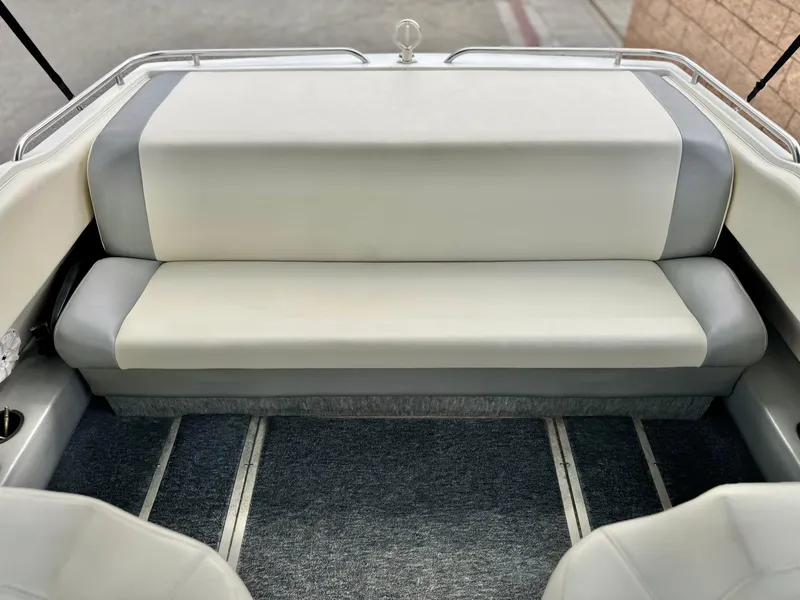 Slide: The Image of 1994 Cobalt 222 boat interior with gray and white seating, carpeted floor. - 14