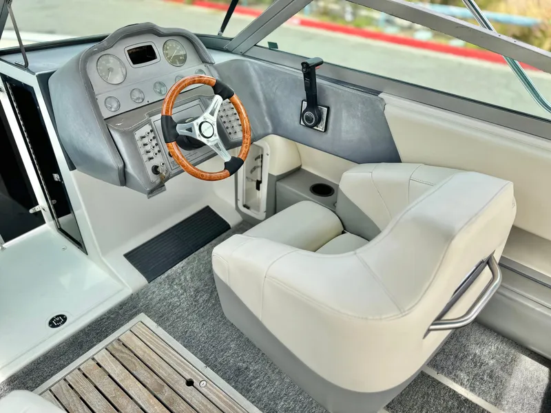 Slide: The Image of Interior of a 1994 Cobalt 222 boat with steering wheel and captain's seat. - 22