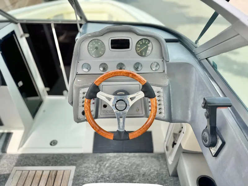 Slide: The Image of Steering wheel and dashboard of a 1994 Cobalt 222 boat, featuring classic design elements. - 23