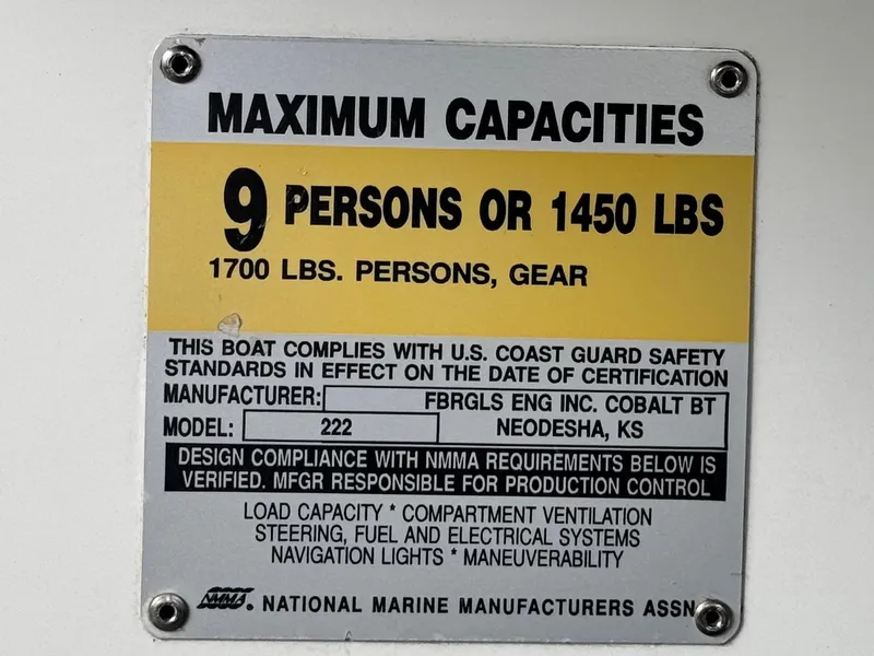 Slide: The Image of Capacity plate for 1994 Cobalt 222 boat, max 9 persons or 1450 lbs, compliant with safety standards. - 26