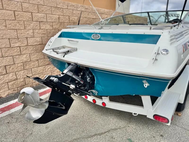 Slide: The Image of 1994 Cobalt 222 boat on trailer, showcasing rear view and propeller. - 6