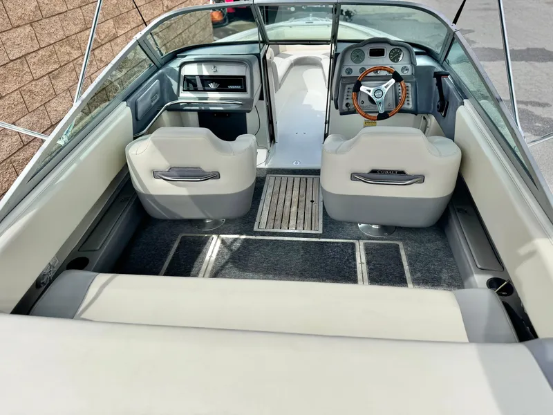 Slide: The Image of 1994 Cobalt 222 boat interior with steering wheel, seating, and dashboard. - 8