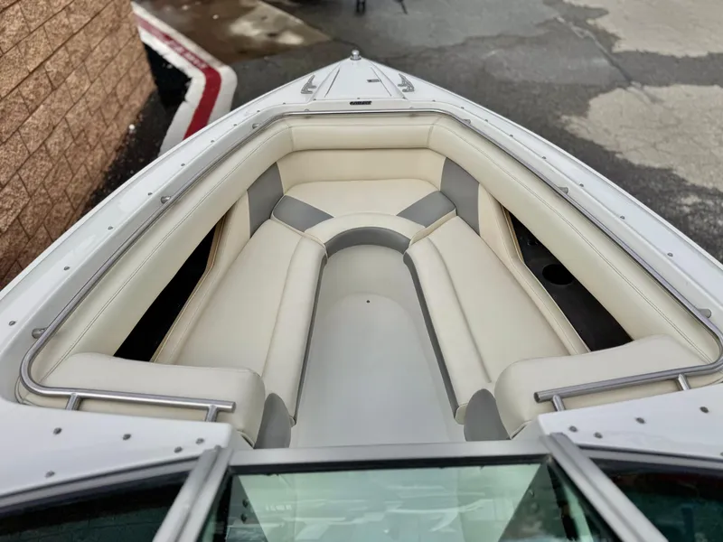 Slide: The Image of 1994 Cobalt 222 boat interior with white cushioned seating and sleek design. - 9