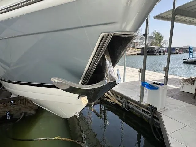 Slide: The Image of 2004 Formula 400 Super Sport boat with anchor, docked by a lakeside marina. - 10
