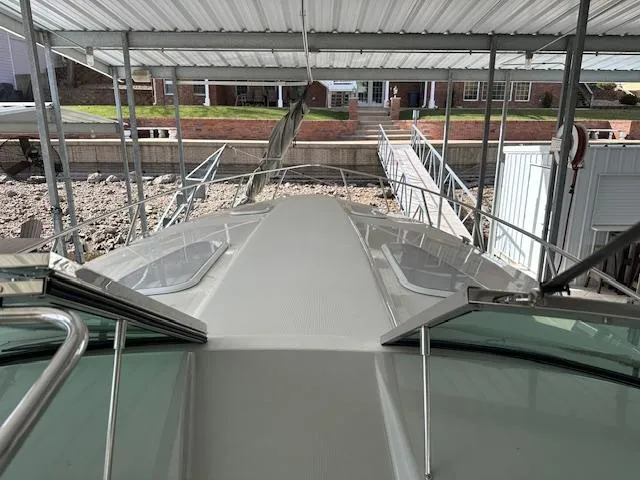 Slide: The Image of 2004 Formula 400 Super Sport boat docked under a covered marina. - 15