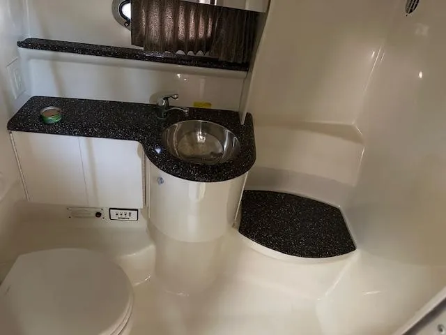 Slide: The Image of 2004 Formula 400 Super Sport boat bathroom with sink, toilet, and countertop. - 17