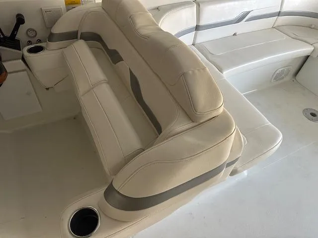Slide: The Image of 2004 Formula 400 Super Sport boat interior with beige seating and cup holders. - 3