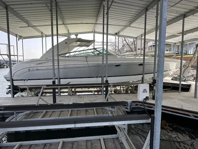 Slide: The Image of 2004 Formula 400 Super Sport boat docked under a covered marina. - 8