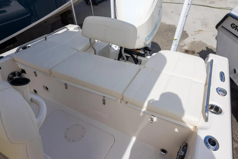Slide: The Image of 2021 Grady-White 251 Coastal Explorer boat interior with cushioned seating and motor. - 12