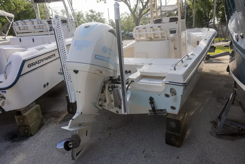 Slide: The Image of 2021 Grady-White 251 Coastal Explorer boat with outboard motor, parked on a trailer. - 2