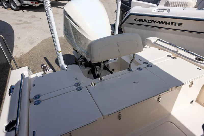 Slide: The Image of 2021 Grady-White 251 Coastal Explorer boat interior with seating and engine view. - 5